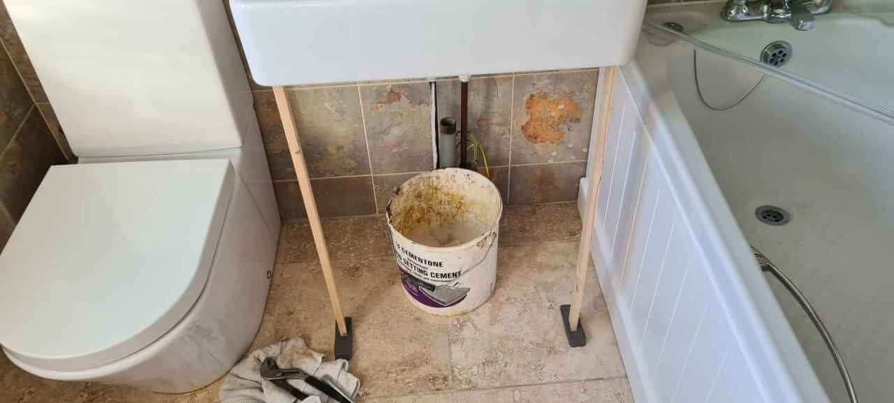 Loosen basin screws and prop up sink to enable pedestal to be extracted